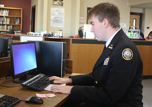 Senior Lucas Stewart goes to print a biology assignment on March 20.