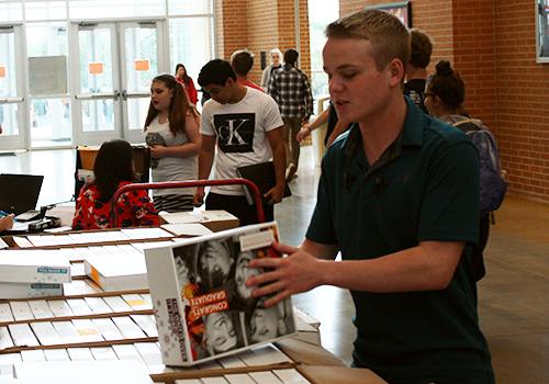 Senior Jacob Seago picks up a package of announcement letters for graduation.