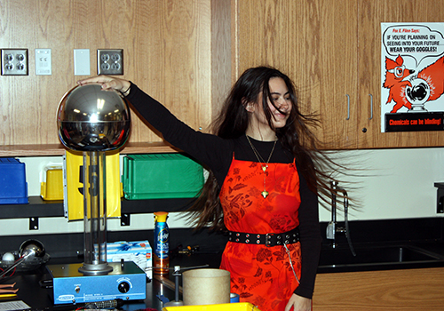 Senior Halie Siepert has a electrifying experience in a physics demo to show how like charges separate on April 19.
