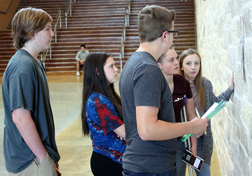 Freshmen Nash Miller, Kelly Carr, Thomas Harris, Hadley Thomas and Emma Hilaman work in stations to solve algebra problems in the main entrance hallway on April 26.
