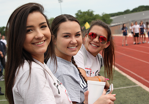 Seniors Jordan Mabie, Miciaya Milani and Kori Navaro cheer on the athletes competing in the STAR track meet on April 27.