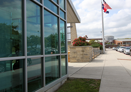 Freshman Iris Bradbury photographs the front of the school for a Journalism I assignment on April 5.