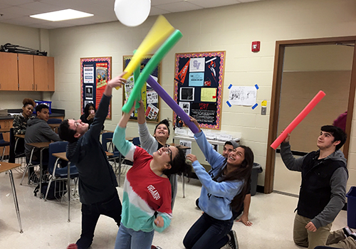 Senior Zac Stager, sopomore Grace Collazo, freshman  Makayla Vallejo, senior Garrett O'Donnell, sophomore Meggan Muzquiz, sophomore Nathen Canales go to strike the ballon as a celebration game after finishing the yearbook on April 4.