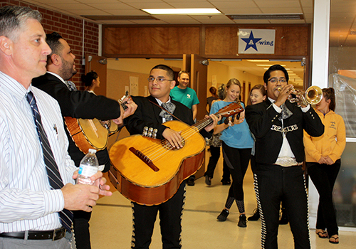 Students and staff laugh as Principal Michael Wahl was serenaded in senior dinging hall by a mariachi band for this year's senior prank on May 22
