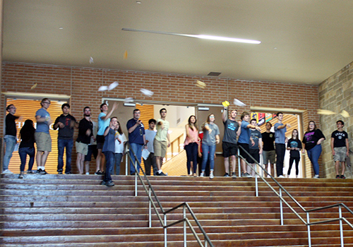 AP physics 1 students to a group test of their paper airplanes lab down the main hallway.