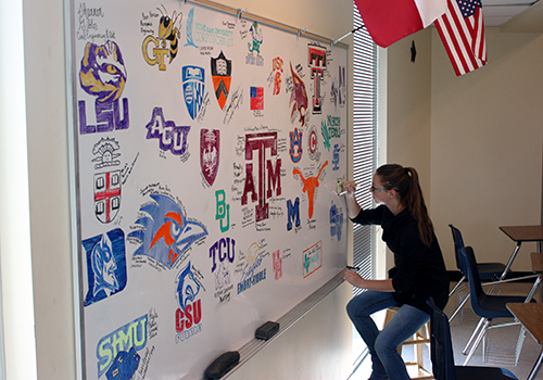 On her last day on campus, senior Sidney Clark draws her college emblem on the designated senior board in teacher Kathryn Rutledge's classroom in D wing on May 29. 
