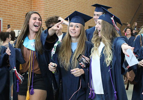 During their senior walk today, seniors Erica Martinez, Lauren Poskon and Haley Oatman celebrate with family and friends.