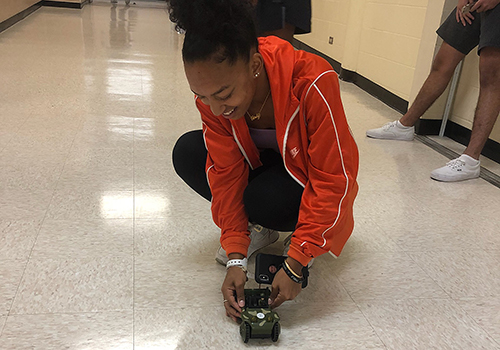 In Kathy Wilson's physics class, sophomore Carmen White sets up the car to see how long it takes to travel from start to finish.