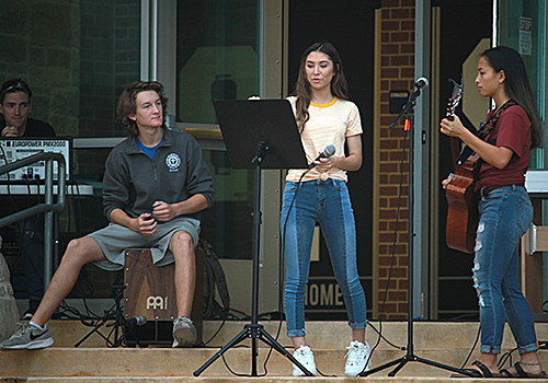 Juniors Lauren Gonzalez, Esther Hicks, and Will Yancosek prepare for their next song at See you at the Pole.