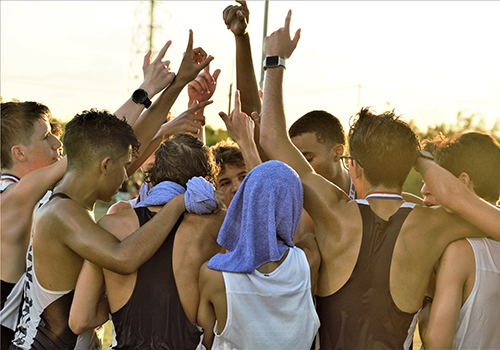 The boys cross country team celebrates their run at the Vista Ridge meet on Aug. 24