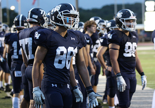 One the sidelines before the Madison loss, tight end Jacob Cox and his teammates prepare to enter the field Sept. 14