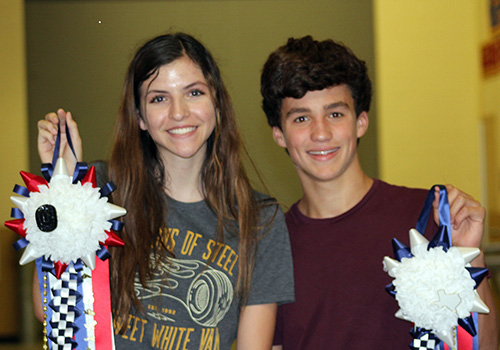 Students in Heather Sanders's floral design class show off the mums they created in class.