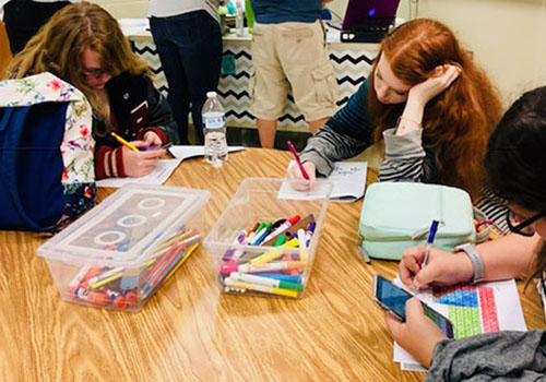 Before the grading period ends, seniors Alysha Hokanson, Samantha Bancroft and Annabelle Sanchez gets work done for their third period  food science class. The class was doing a storybook project and counted as a major grade. “It was stressful at some moments.” Annabelle Sanchez said. “But we worked diligently on it so we ended up turning it in on time.”