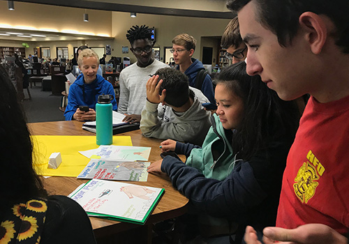 Sophomore Sierra Hugos struggles with deciding which extra credit assignment she should turn in for chemistry while sophomore Samuel Lackey attempts to help her out.