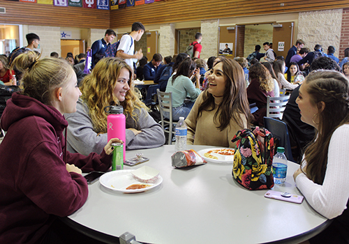 During C lunch, seniors Kiersten Tomerlin, Abigail Johnson and Olivia Anaya share a laugh with Alexys Vallejo in the senior dining hall.