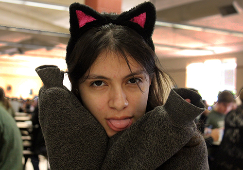 Ready for Halloween fun, junior Victoria Quinones puts on her cat face in the cafeteria.