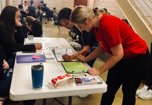 During second period, Seniors Hannah Hayes and Madeline Brown sign up for the annual school blood drive. 