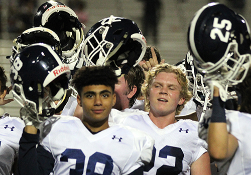 After kicking the game-winning field goal to defeat the Steele Knights 19-17, senior Mason Reid (right) celebrates with teammate Anthony Valdez.