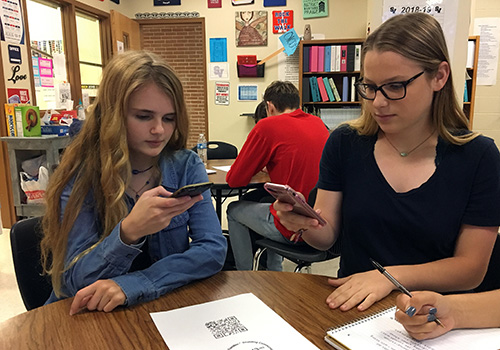 Senior Kaylin Kline and junior Jacquelyne LaFond prepare for their first FACS friend visits by testing the QR code scanner on their phones. 