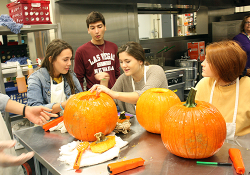 One day before Halloween, students in Margaret Marrucci's culinary class carve pumpkins in the Blue Star Cafe.