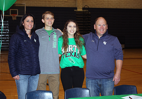Flanked by cross country coaches Britney Lanehart and Nathan Nunley, seniors Mason Garner and Arianna Gonzales celebrate signing their letters of commitment to the University of North Texas.
