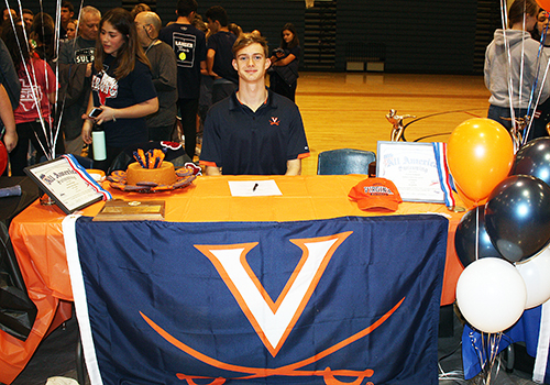 Konnor Klinksiek signed his letter to swim for the University of Virginia Cavaliers.