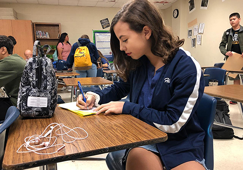 Freshman Hannah Pellerin starts to work on an essay after reading book "Of Mice and Men."
