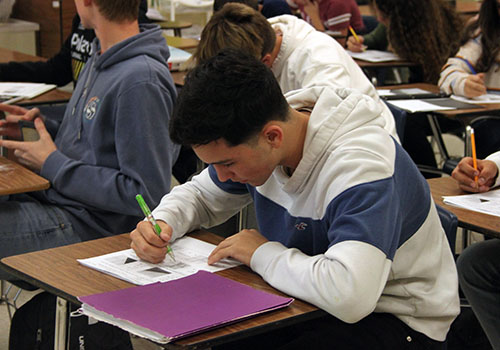 Freshman Andrew Montalvo focuses on his Algebra 1 work as he tries to remember what he learned before the Thanksgiving break.