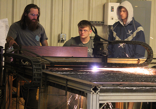 Ag teacher Josh DeWaters gives senior Koby Suggs a lesson during the fifth period Ag Structure, Design and Fabrication class Dec. 5.