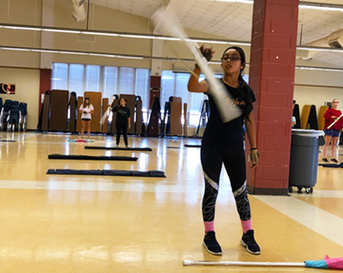 Freshman Ariel Melendez warms up on her rifle during her seventh period color guard class. “I think that it will be interesting to see a skill level difference between newbies and veterans, separating us and all," Melendez said. 