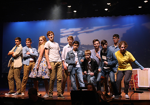 The Jets of 'West Side Story' along with junior Rileigh McCullough end their act by posing center stage.