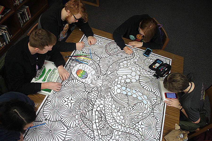 Before school, juniors Josephine Ford, Max Oliver, Liahm Nowak, Abigail Lewis and Carsyn Chambers add their artistic touches to the giant coloring page in the library Thursday, Jan. 24. 