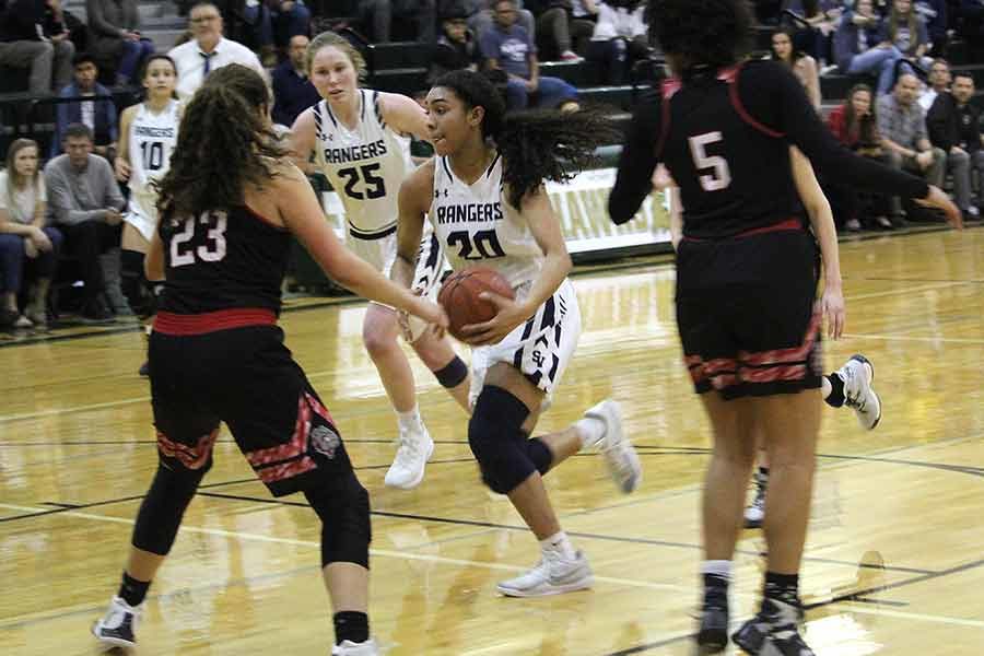 Junior Anika McGarity drives through the lane against Bowie at Canyon Lake High School on Feb. 11. McGarity ties school record with 73 three-pointers this season.
