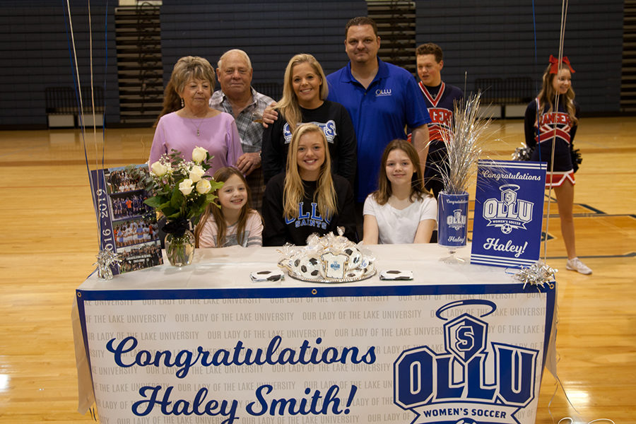 Surrounded by friends and family, Haley Smith inks her commitment to play soccer at Our Lady of the Lake University in San Antonio.