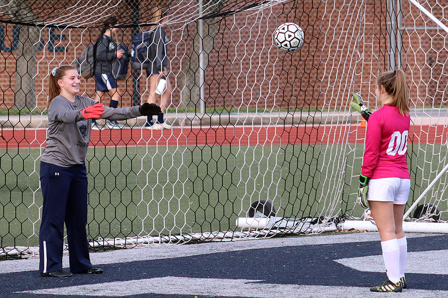 Junior varsity goalkeeper freshman Claire Temple and varsity goalkeeper freshman Kayla Petro toss a ball before the game against New Braunfels on Feb 26.