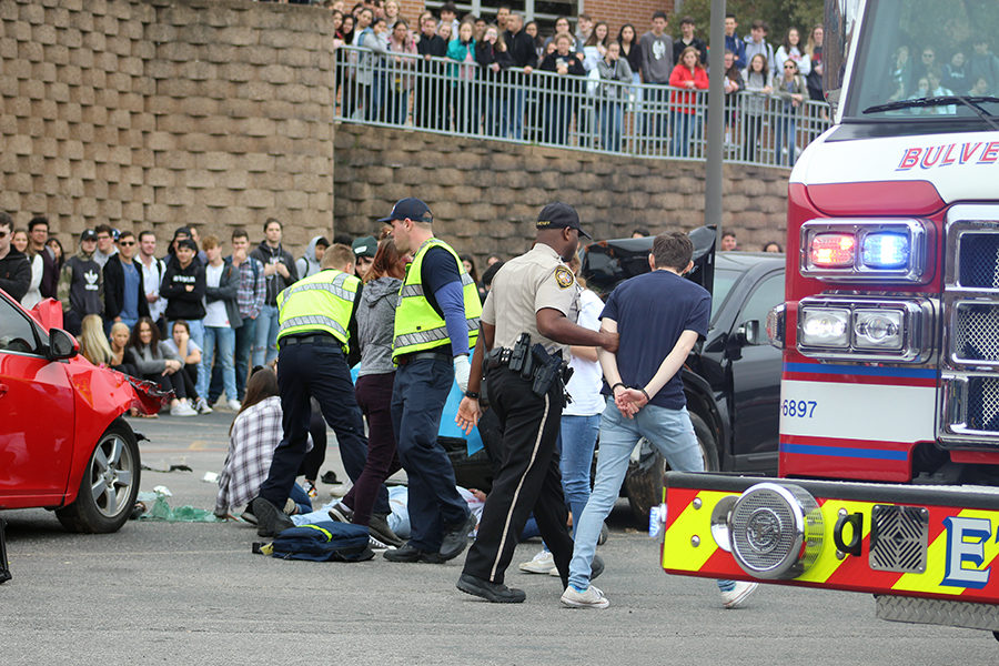 First responders give aid to victims and take away the drunk driver, portrayed by Chase Carson.