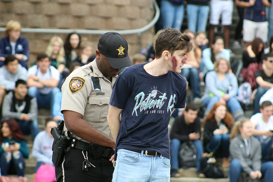 The drunk driver, portrayed by Chase Carson, gets cuffed by a Comal County Sheriff's deputy.