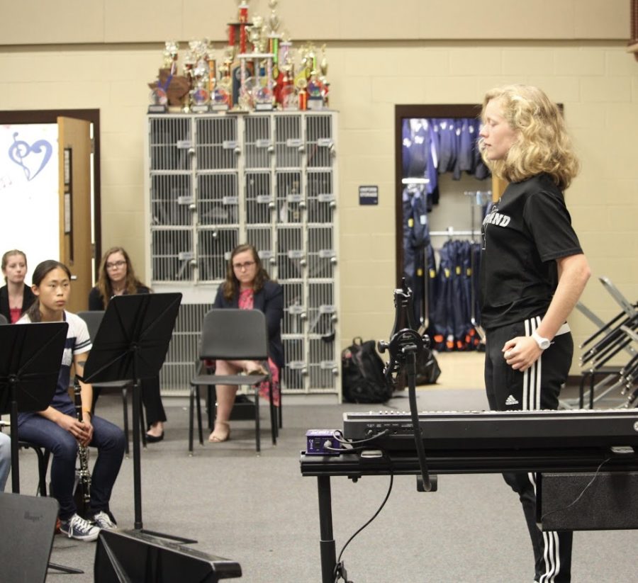Sophomore french hornist stands firm for her audition as sophomore clarinetist Iris Bradbury, sophomore flutist Maya McBrayer, and junior Caroline Kuhn observes.