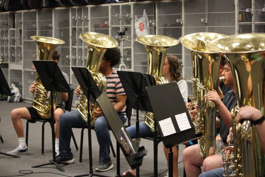 Tuba players Kenyon Clark, Darius Young, Kyra Schobel, and Josh Davidson blare out the fight song. 