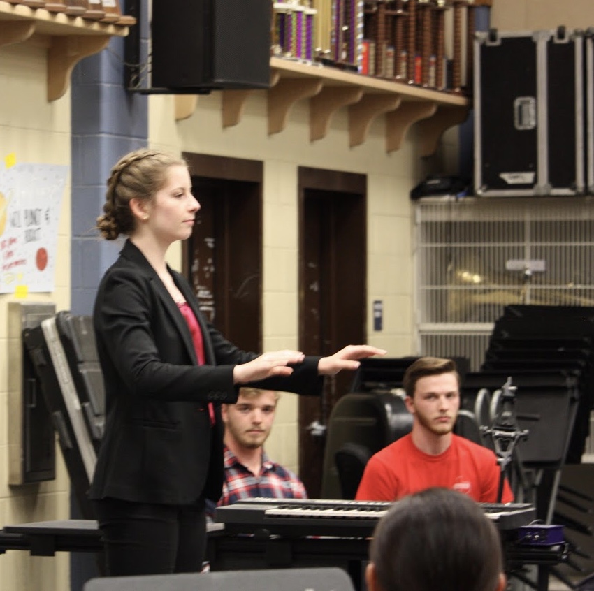 2019-2020 drum major Lindsay Pattison focuses on her execution as seniors Cade Gibson and Nathaniel Pfahning watch.