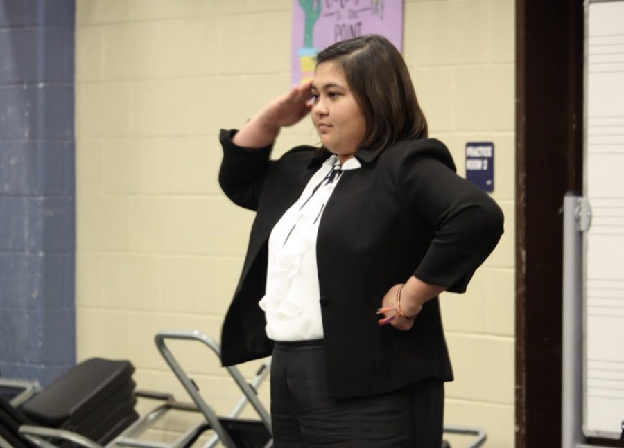 2019-2020 drum major Gabi Wilson salutes to the crowd.