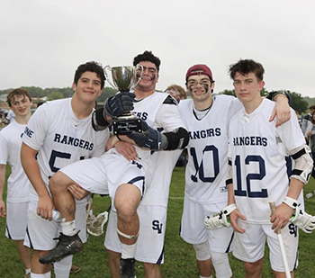 Sophomore defensemen Sam Garibay (far left), junior midfielder Jacob Forton, (middle) , senior defenseman Wyatt Tomallo (right), and senior midfielder Jack Bracher (far right). Smithson Valley Lacrosse beat Reagan 19-9 in blowout senior night win, win district rivalry and  Randall Perkins trophy 