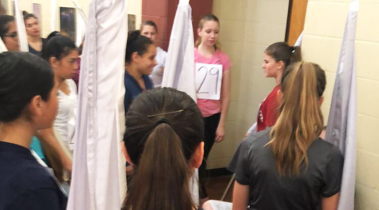 Senior Jordan Leyendecker gives some tips to the newbies at color guard tryouts 2018. 