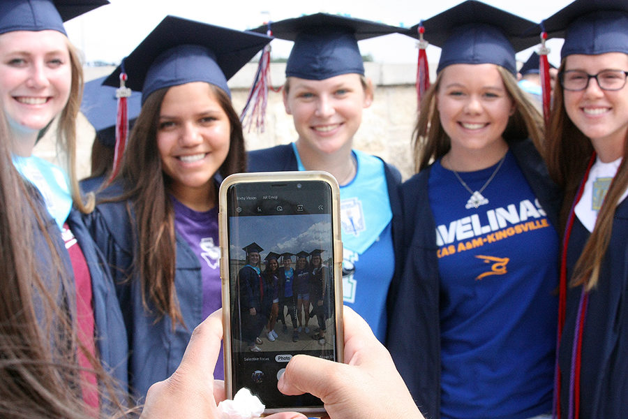 Hannah Kollmansbarger, Carissa Vasquez, Kaylin Kine, Presley Smith and Mackenzie Thornley pose for a photo in front of the school.