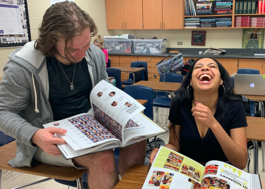 Seniors Jack Mobley and Rebecca Covington flipping through this years yearbook, recalling past books and cherishing their last.