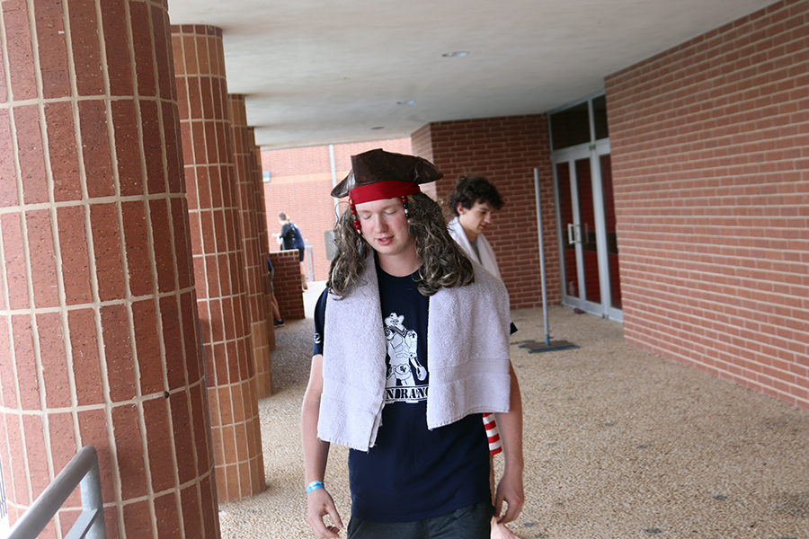 Junior Tim Upton drys off after a swim in the ranger pool on Tuesday, May 21. Students were given free time to play in the water once everyone was done testing their boat. 