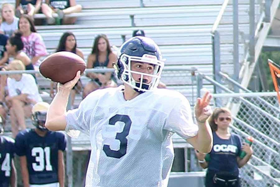 While the football team scrimmages Brandeis on Aug. 23, senior Luke Gombert gets some reps as the new starter.