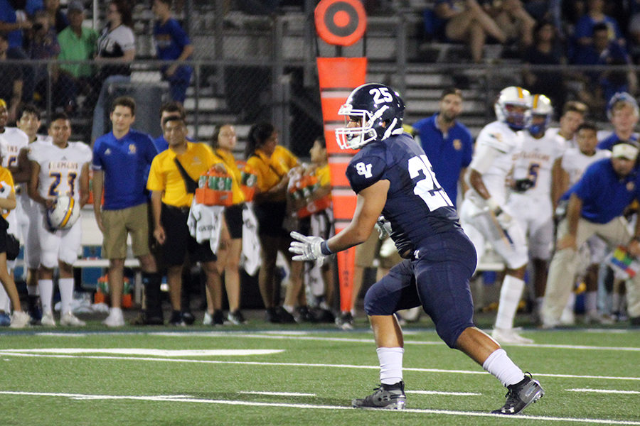Following the ball, junior linebacker Americas Sanders makes his way to stop Clemens during their 15-7 loss on Sept. 20.