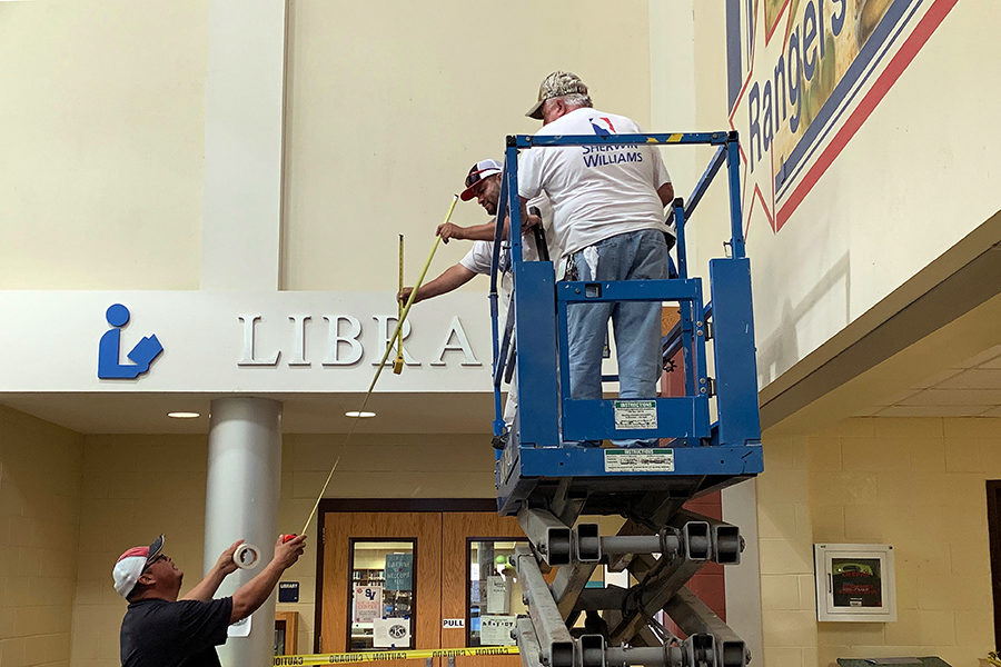 On a scissor lift in fron the Ranger mural near the library, mainentance workers Bill Logan and Rene Lopez prepare to paint
over the Ranger mural in downstairs B wing Friday morning. The mural was replaced with a blue square that will bear white vinyl lettering with an SV and Rise Above in white.
