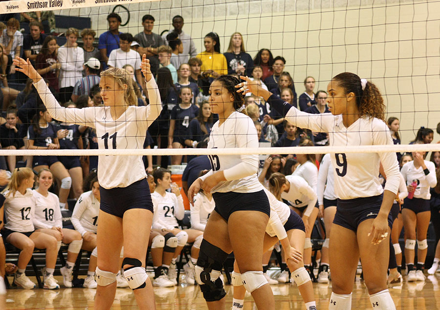 Teammates Jada West, left, and Esther Duglass welcome senior outside hitter Tanyse Moehrig back to full-time duty on the court Friday. Moehrig recovered from a knee injury during basketball season last year.